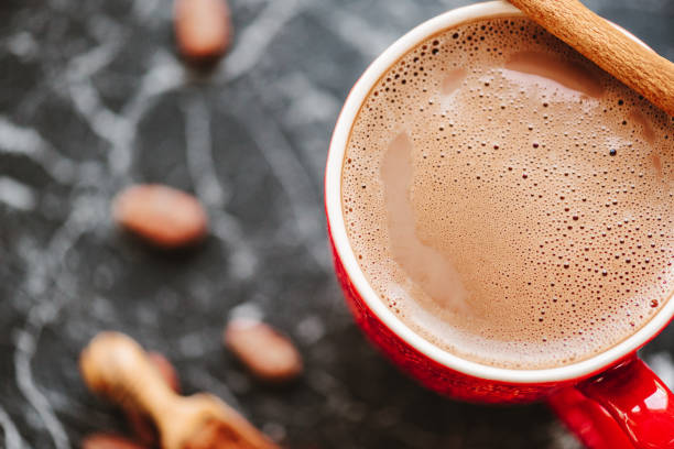 Whisking melted chocolate bar in a mug for a perfect cup of hot cocoa