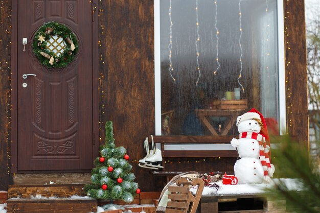 DIY Christmas front door decor with ornaments and lights